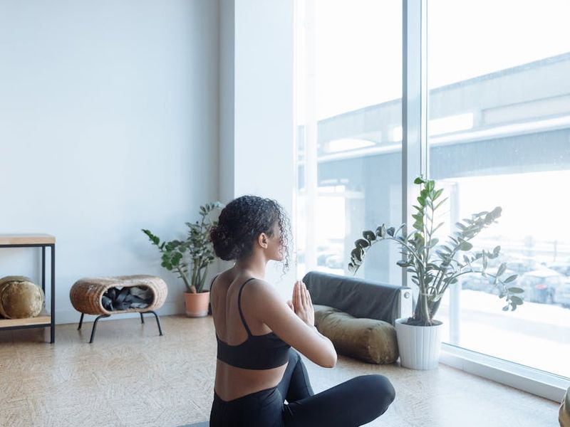 Minimalist yoga studio with mats and large windows.